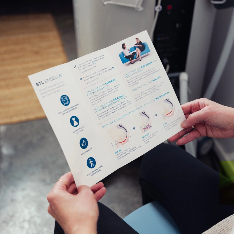 hands holding emsella treatment pamphlet